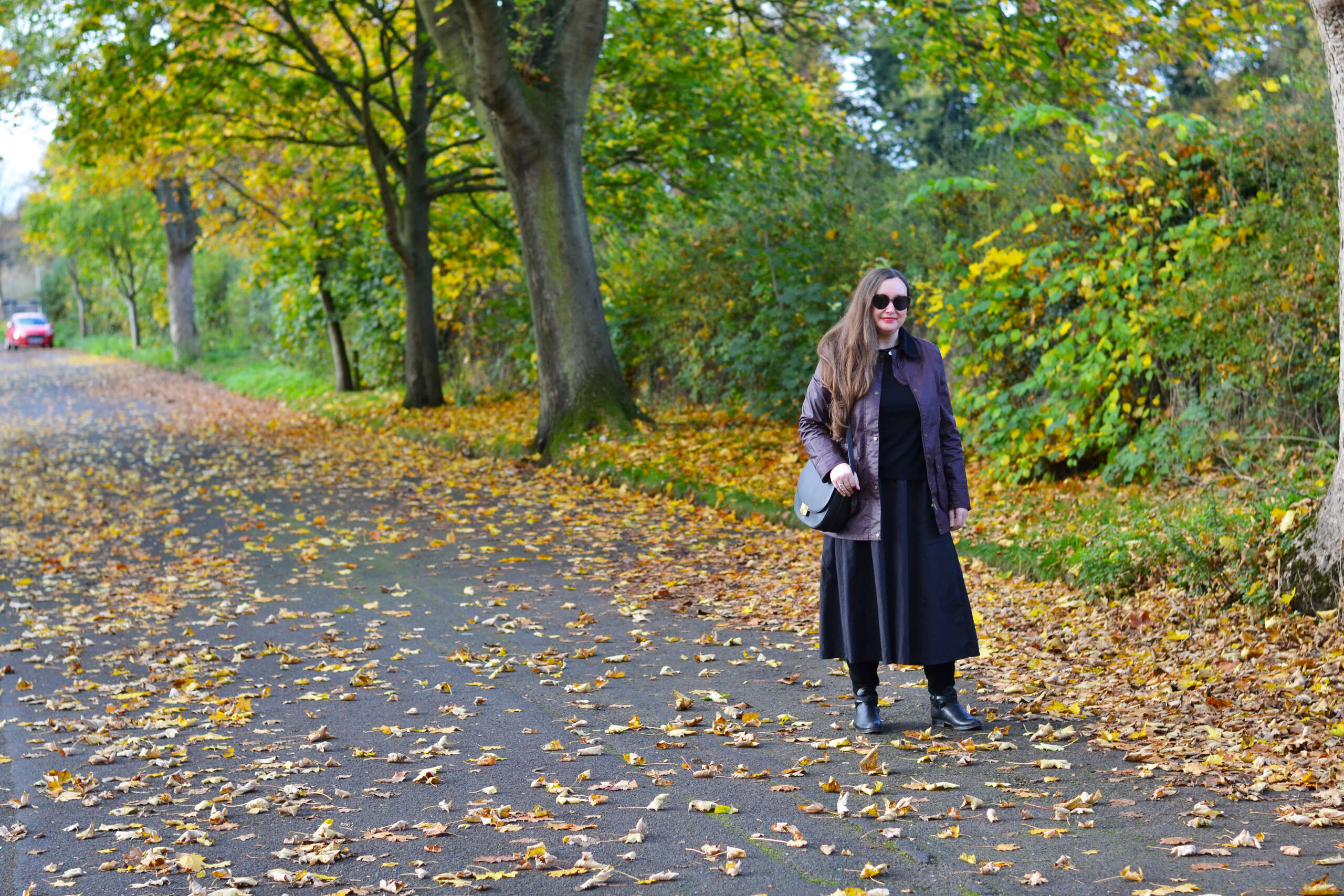 Barbour wax jacket with black top and midi skirt outfit